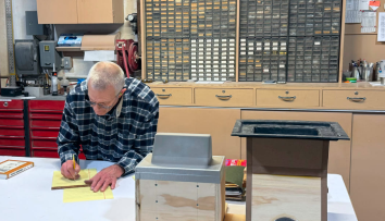 a thermoforming engineer draws a custom plastic part on a sheet of paper