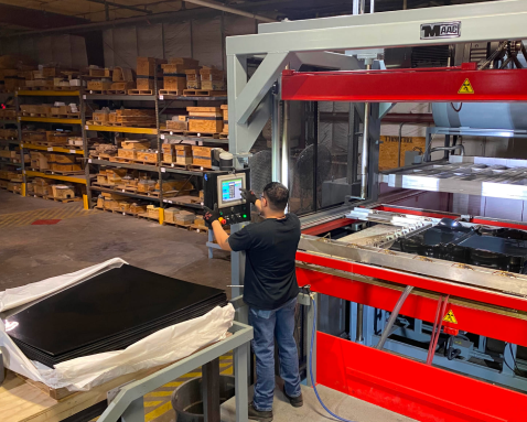 thermoforming engineer entering information in a computer at a custom plastic forming company